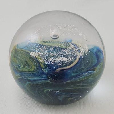earth paperweight cremation ashes in glass top view
